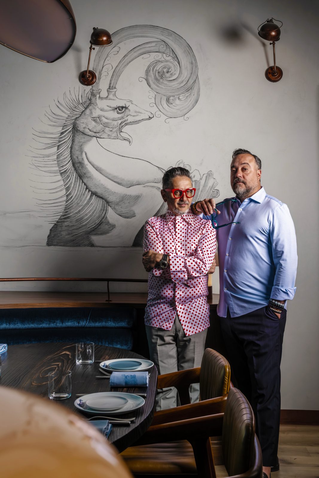 Brasero Atlántico Bahrain: Two members of the team in front of the restaurant’s mural