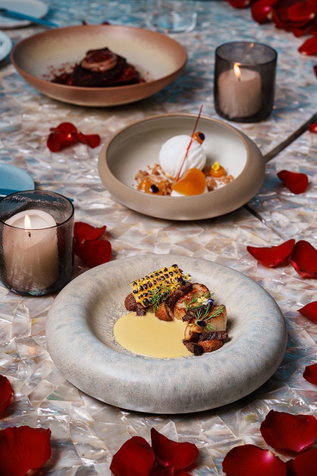 Brasero Atlántico Bahrain: Plated dishes on the terrace, set for a romantic dinner
